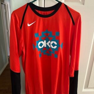 Nike Orange and Black Long Sleeve Dri-FIT OKC Thunder City Edition.